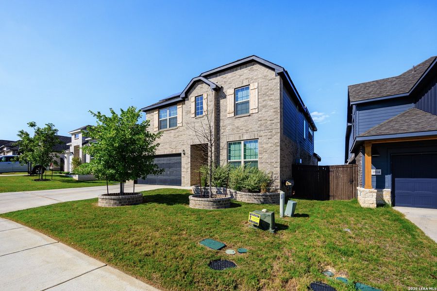 Front exterior of a new home in Bison Ridge, San Antonio, TX, highlighting curb appeal (Image 26).