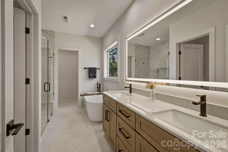 ...and here is the owners' private bath. Features include a dual sink, drawer space and a huge lighted vanity mirror with an anti fog feature. Additionally, the bathroom is equipped with a Panasonic Whisper Quiet recessed bathroom fan & can light which features an ultra-quiet fan hidden above the ceiling and an integrated, dimmable LED recessed light. ...and here is the owners' private bath. Features include a dual sink, drawer space and a huge lighted vanity mirror with an anti fog feature. Additionally, the bathroom is equipped with a Panasonic Whisper Quiet recessed bathroom fan & can light which features an ultra-quiet fan hidden above the ceiling and an integrated, dimmable LED recessed light.