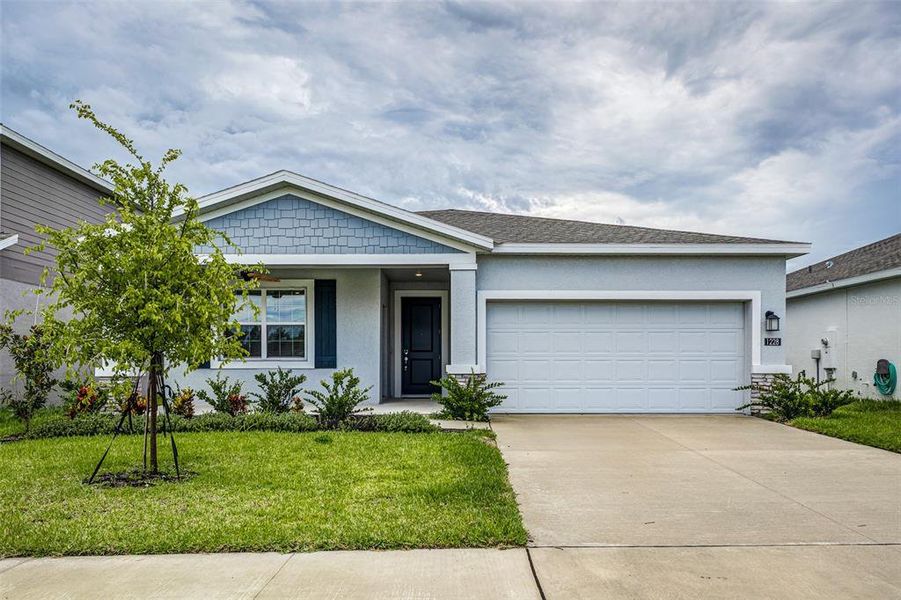 Front exterior of a new home in , Winter Haven, FL, highlighting curb appeal (Image 21). Front exterior of a new home in , Winter Haven, FL, highlighting curb appeal (Image 21).