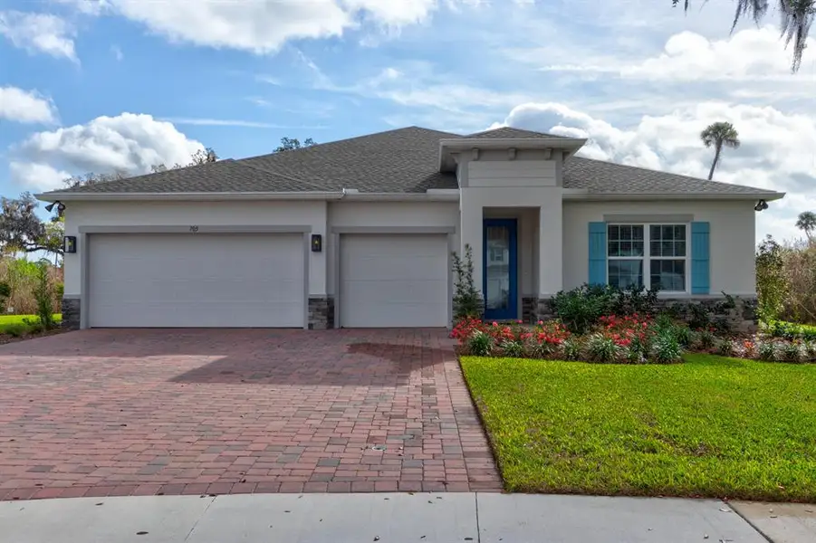 Front exterior of a new home in Copper Creek, New Smyrna Beach, FL, highlighting curb appeal (Image 2). Front exterior of a new home in Copper Creek, New Smyrna Beach, FL, highlighting curb appeal (Image 2).