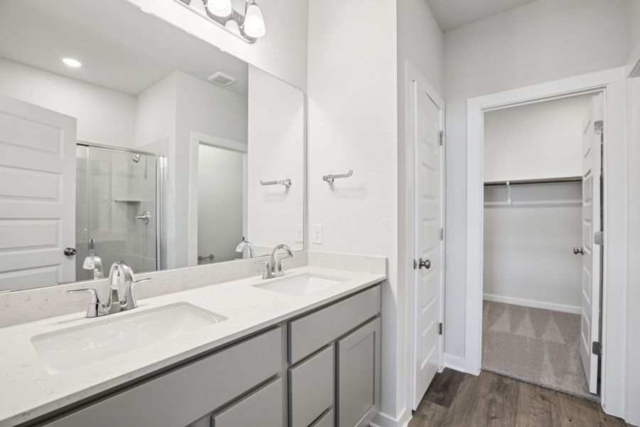 A bathroom with a large mirror. A bathroom with a large mirror.