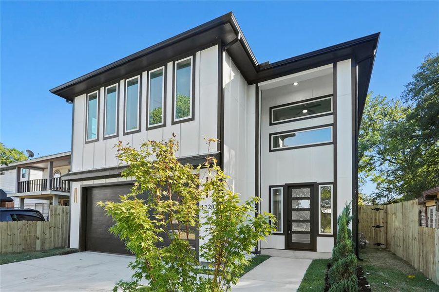 Contemporary house with a garage, board and batten siding, and concrete driveway