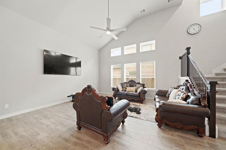 A chic living room space flooded with natural light is delightful! The wall of windows not only brings in abundant sunlight but also offers expansive views of the surrounding landscape, connecting the indoors with the outdoors in a seamless way.