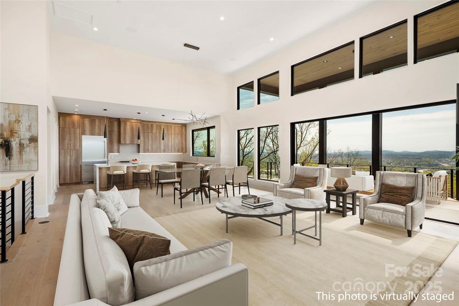 The great room flows seamlessly to the dining area and gourmet kitchen (virtually staged)