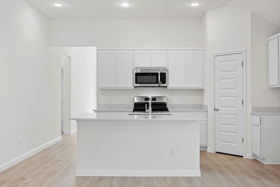 Kitchen in the Cypress home plan by Trophy Signature Homes - REPRESENTATIVE PHOTO