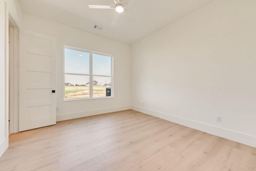 2nd bedroom, ensuite bathroom,  door out to future pool.