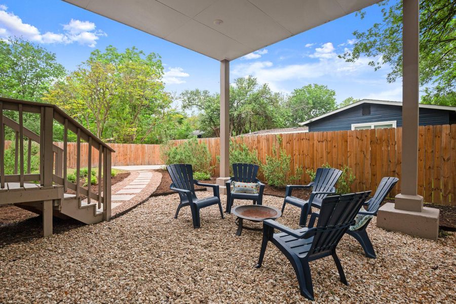 Covered patio area featuring a gravel ground cover and a stepping stone path