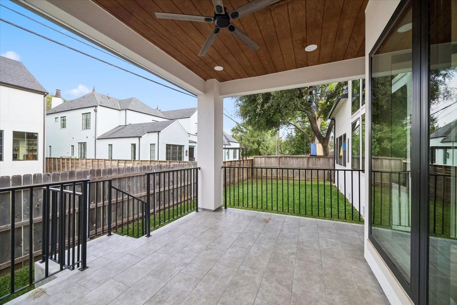 A fan and recessed lighting mounted in the wood panel ceiling serve teh space.