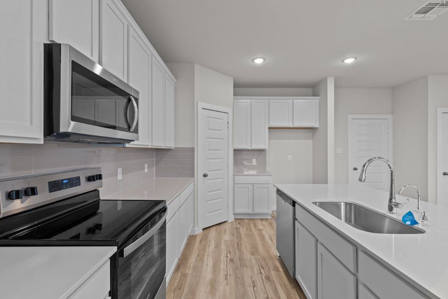 A kitchen with white cabinets. A kitchen with white cabinets.