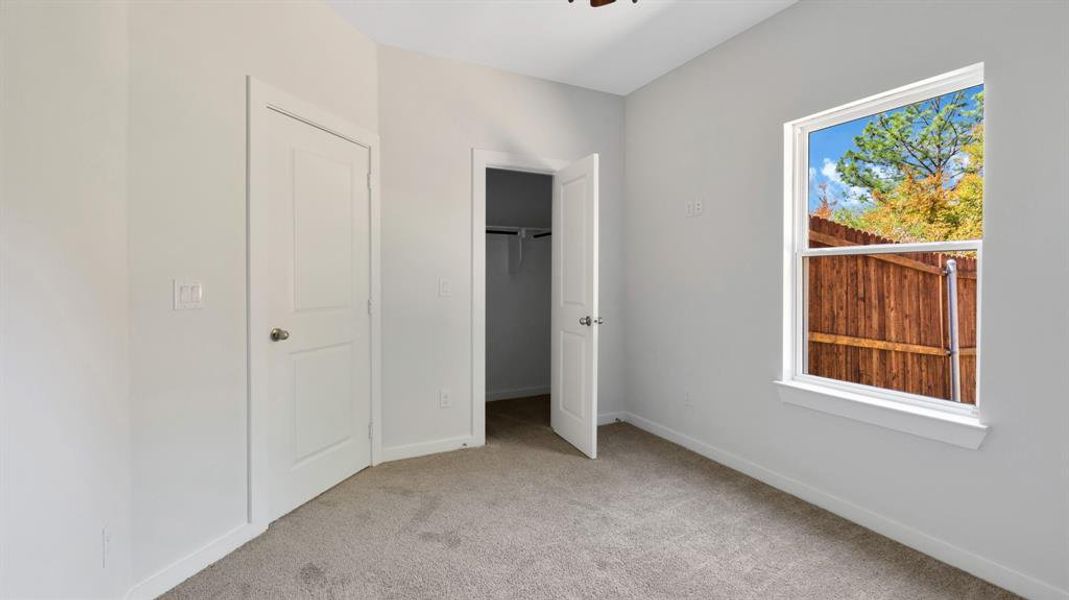 Unfurnished bedroom featuring light colored carpet