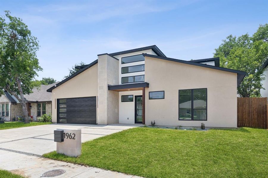 Modern home with a garage and a front lawn