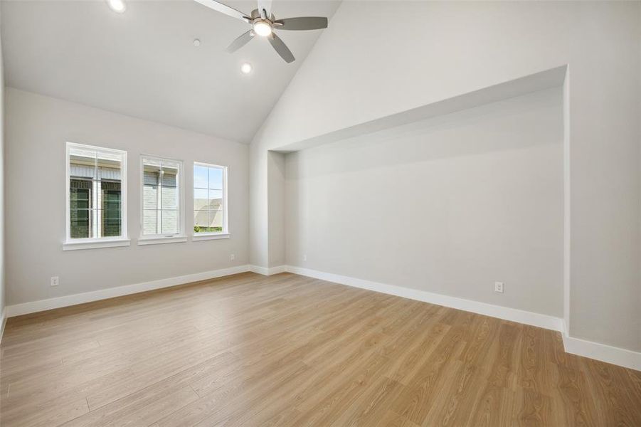 Oversized Primary Suite featuring Cathedral ceilings and all Laminate Wood Flooring