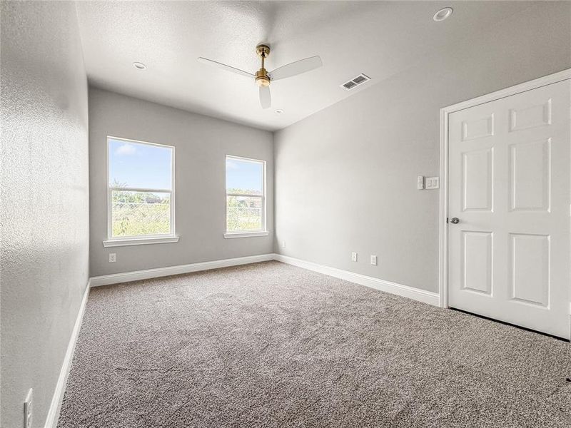 Modern kitchen featuring white shaker cabinetry, light-colored countertops, stainless steel appliances, and wood-finish flooring Modern kitchen featuring white shaker cabinetry, light-colored countertops, stainless steel appliances, and wood-finish flooring