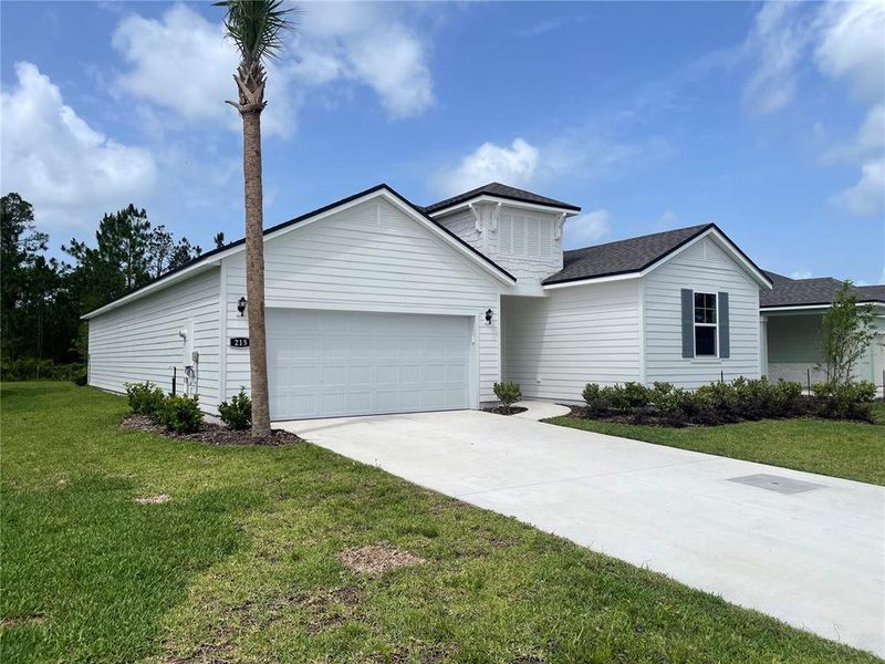 Front exterior of a new home in Magnolia Series at Seminole Palms, Palm Coast, FL, highlighting curb appeal (Image 22).