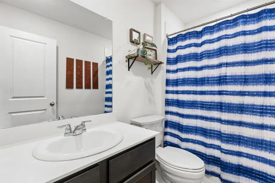 Full bathroom with vanity and a shower with curtain Full bathroom with vanity and a shower with curtain