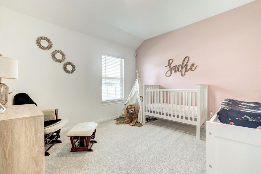 Bedroom featuring carpet floors and lofted ceiling