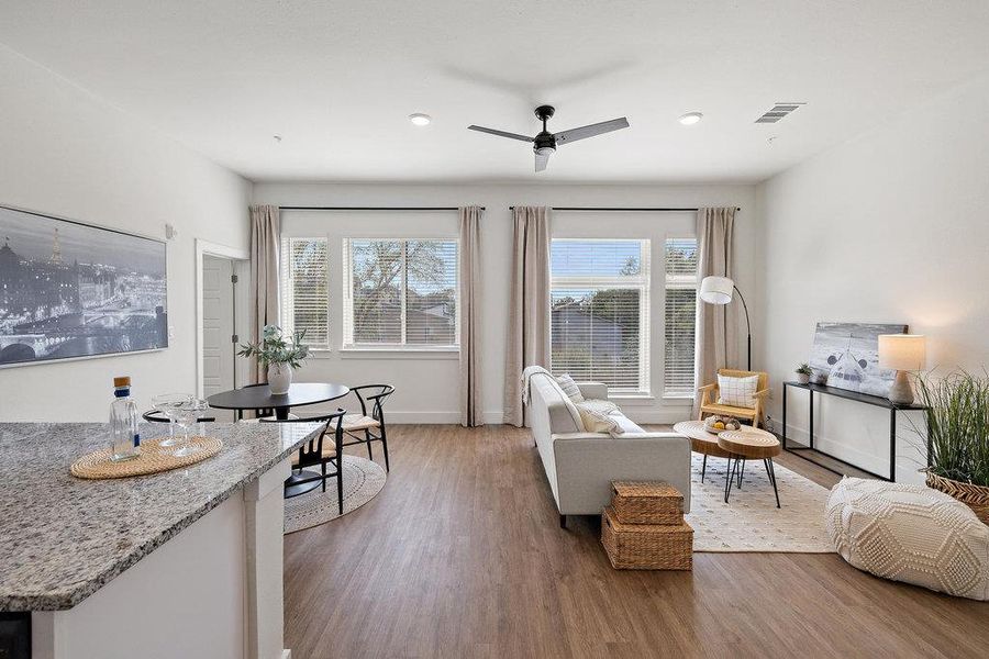 Living area with dark wood-type flooring and a ceiling fan