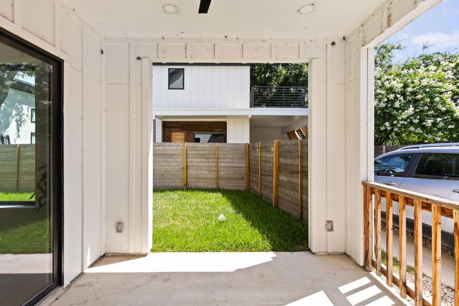 A well-maintained lawn provides a green oasis, bordered by a privacy fence, enhancing this contemporary outdoor space.