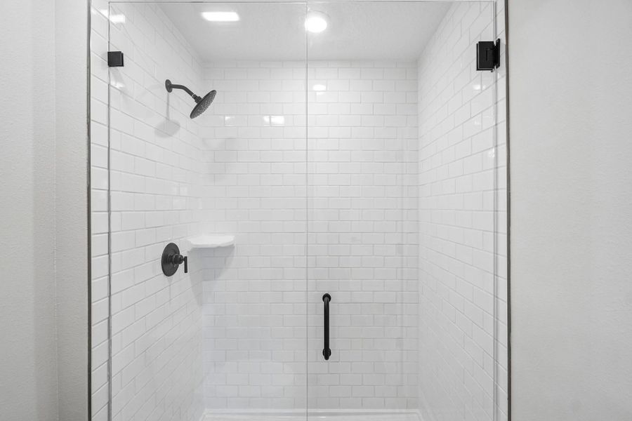 Primary bathroom has a frameless walk-in shower