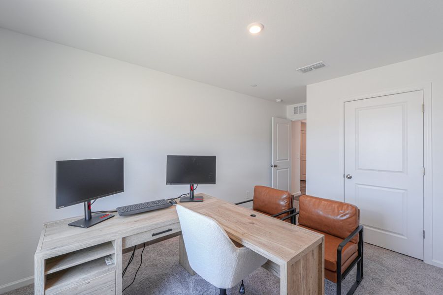 A room with a desk and a computer. A room with a desk and a computer.