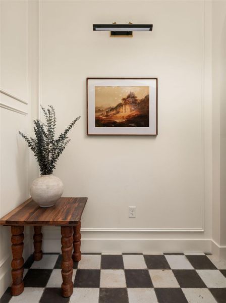 Black and white checkerboard flooring offers a unique touch to this welcoming entrance.