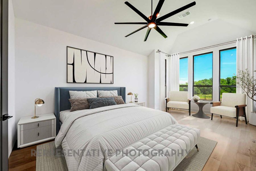 Bedroom with wood finished floors, a ceiling fan, and lofted ceiling Bedroom with wood finished floors, a ceiling fan, and lofted ceiling