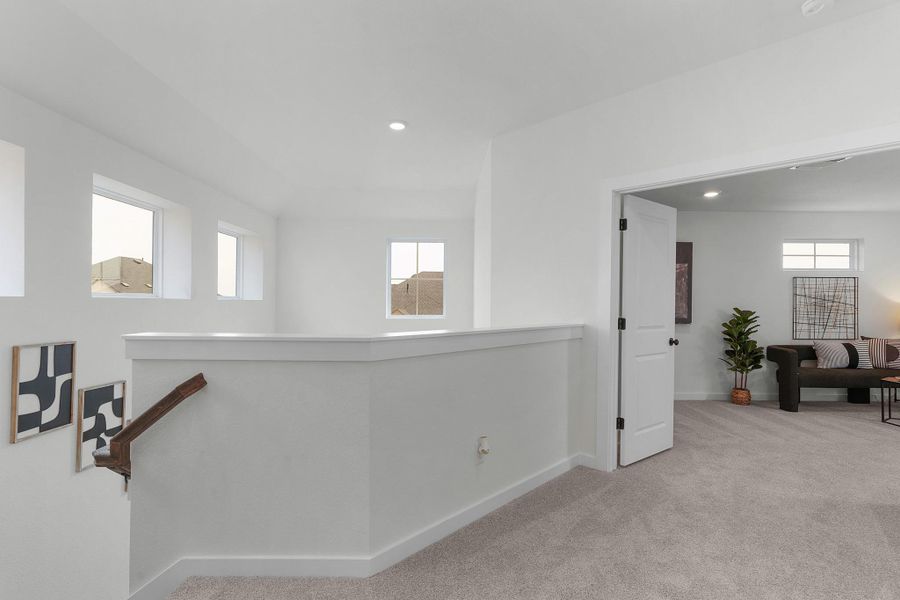 Hallway featuring baseboards, plenty of natural light, carpet floors, an upstairs landing, and recessed lighting