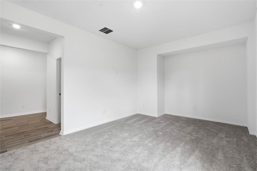 The spacious Den offers cozy carpet flooring, a large window, and a functional built-in niche, perfect for a media center or display shelves. The spacious Den offers cozy carpet flooring, a large window, and a functional built-in niche, perfect for a media center or display shelves.