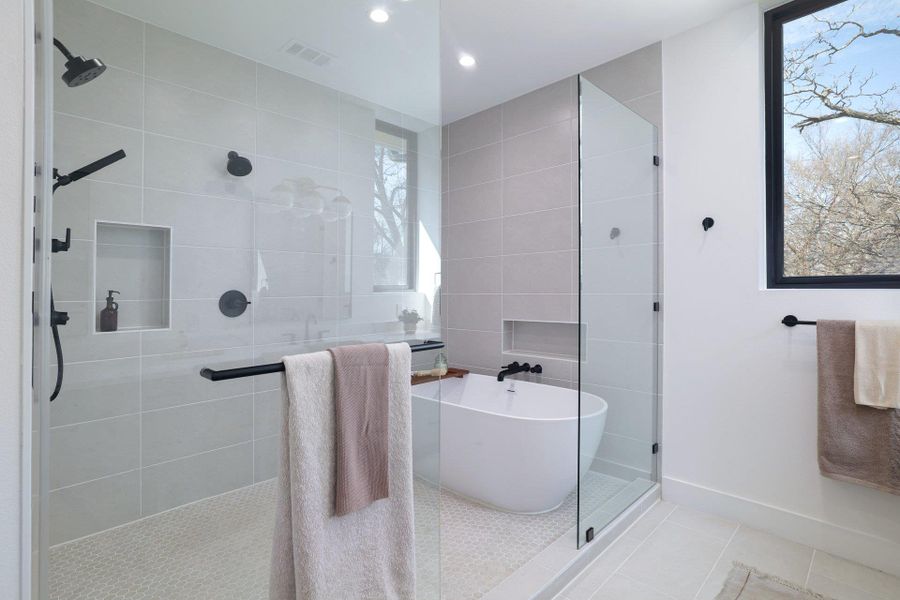 Full bath featuring a shower stall, tile patterned flooring, a freestanding bath, tile walls, and recessed lighting