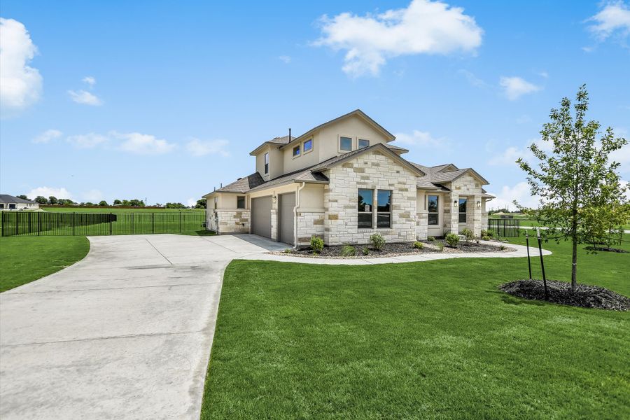 Front exterior of a new home in Scofield Farms Estates, Georgetown, TX, highlighting curb appeal (Image 24).