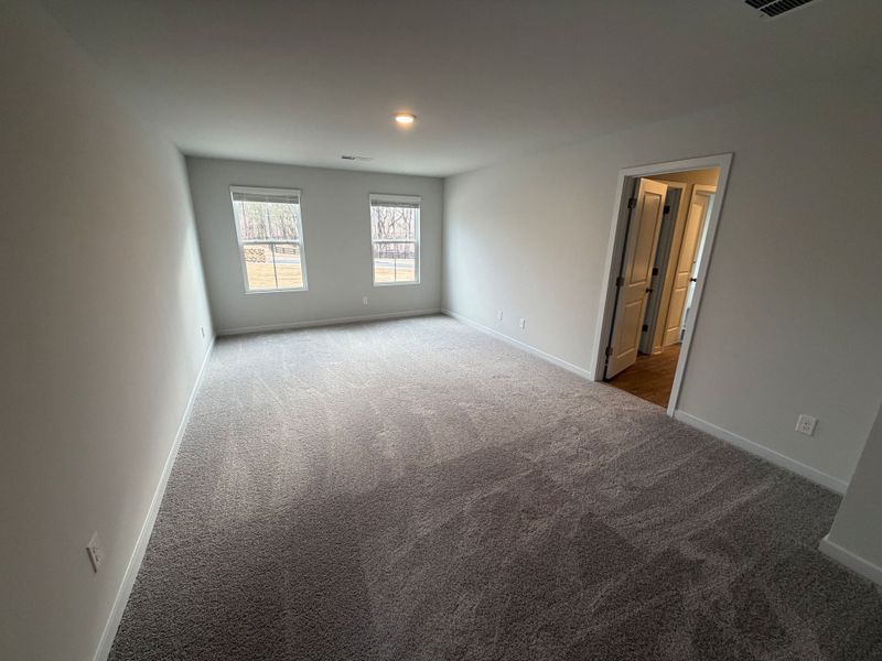 A room with a carpet and a door. A room with a carpet and a door.