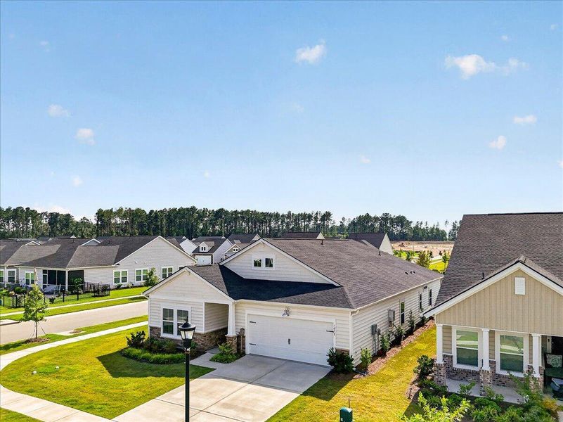 Front exterior of a new home in Horizons at Summers Corner | 55+, Summerville, SC, highlighting curb appeal (Image 27). Front exterior of a new home in Horizons at Summers Corner | 55+, Summerville, SC, highlighting curb appeal (Image 27).