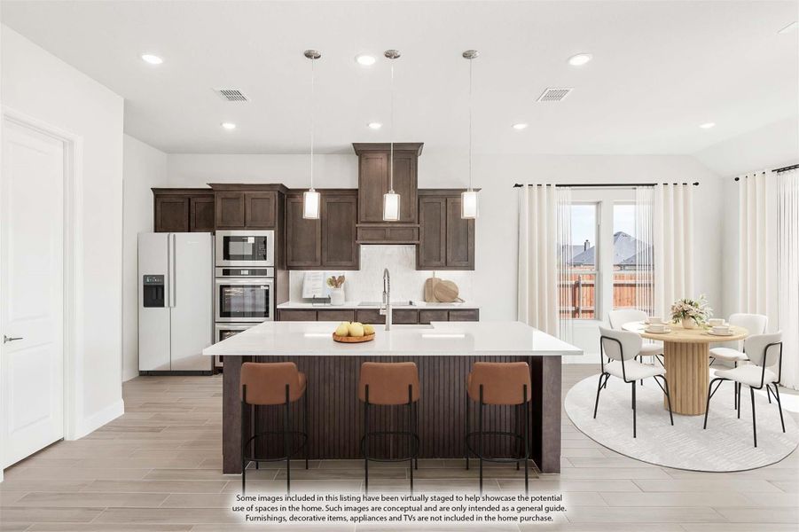 Kitchen with dark wood cabinets, large island with bar seating, stainless appliances, and adjacent dining area with round table. Kitchen with dark wood cabinets, large island with bar seating, stainless appliances, and adjacent dining area with round table.