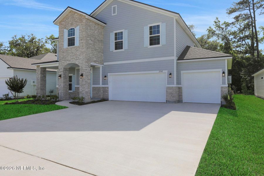 Front exterior of a new home in Jennings Farm, Middleburg, FL, highlighting curb appeal (Image 23). Front exterior of a new home in Jennings Farm, Middleburg, FL, highlighting curb appeal (Image 23).