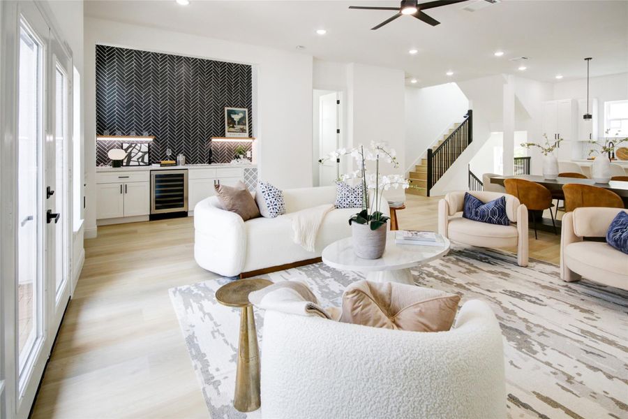Looking from the rear of the living room toward the kitchen. You also can see the powder bath and fully functional wet bar. Looking from the rear of the living room toward the kitchen. You also can see the powder bath and fully functional wet bar.
