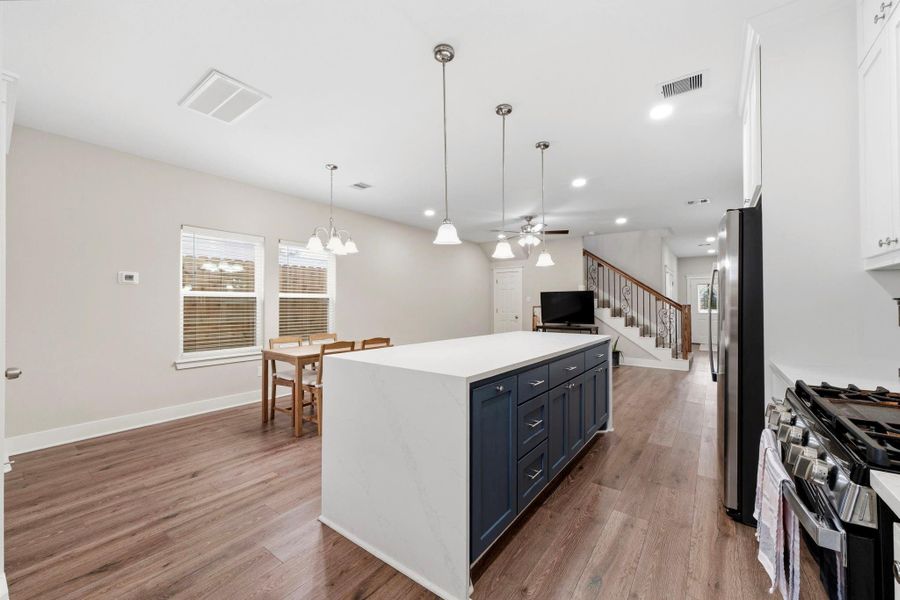 Energy efficient stainless steel appliances complement the kitchen's timeless design and functionality.