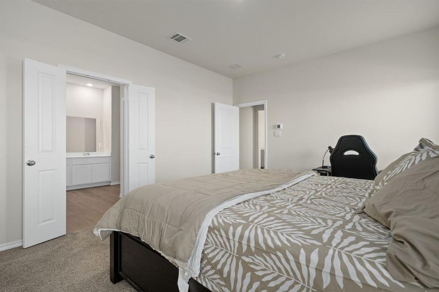 Bedroom with light carpet and baseboards Bedroom with light carpet and baseboards