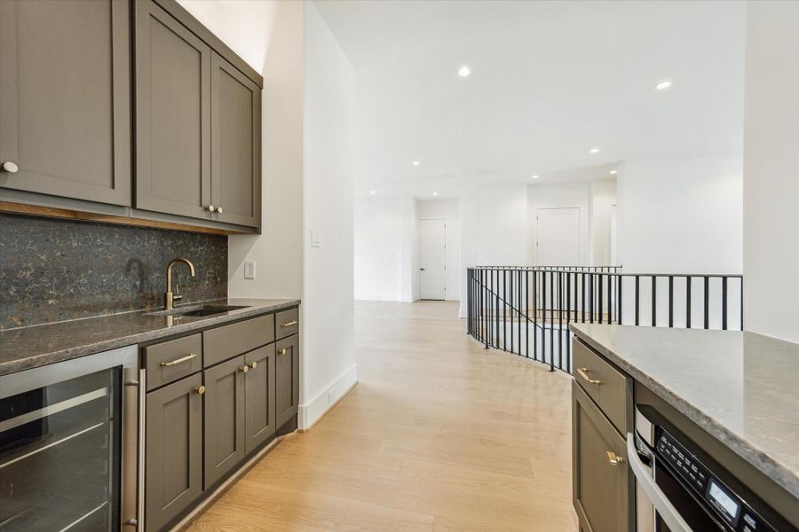Wet bar on the second floor - features built-in cabinets, wine/beverage cooler and quartz countertop.