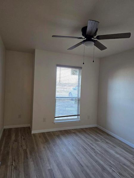 Unfurnished room featuring light wood-style floors and ceiling fan Unfurnished room featuring light wood-style floors and ceiling fan