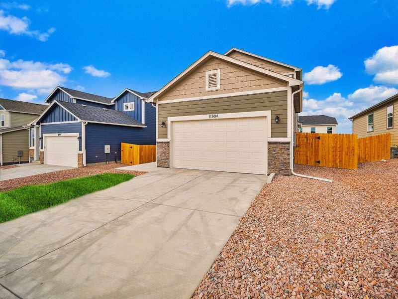 Front exterior of a new home in Ridge at Lorson Ranch, Colorado Springs, CO, highlighting curb appeal (Image 11).