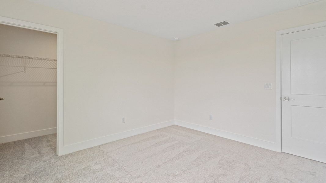 The Sweetgum Spacious and Bright secondary bedroom upstairs in Trailside at Mount Dora by DRB Homes