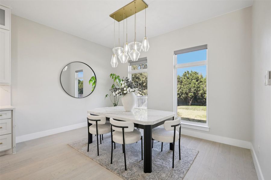 Dining area featuring light wood finished floors and baseboards