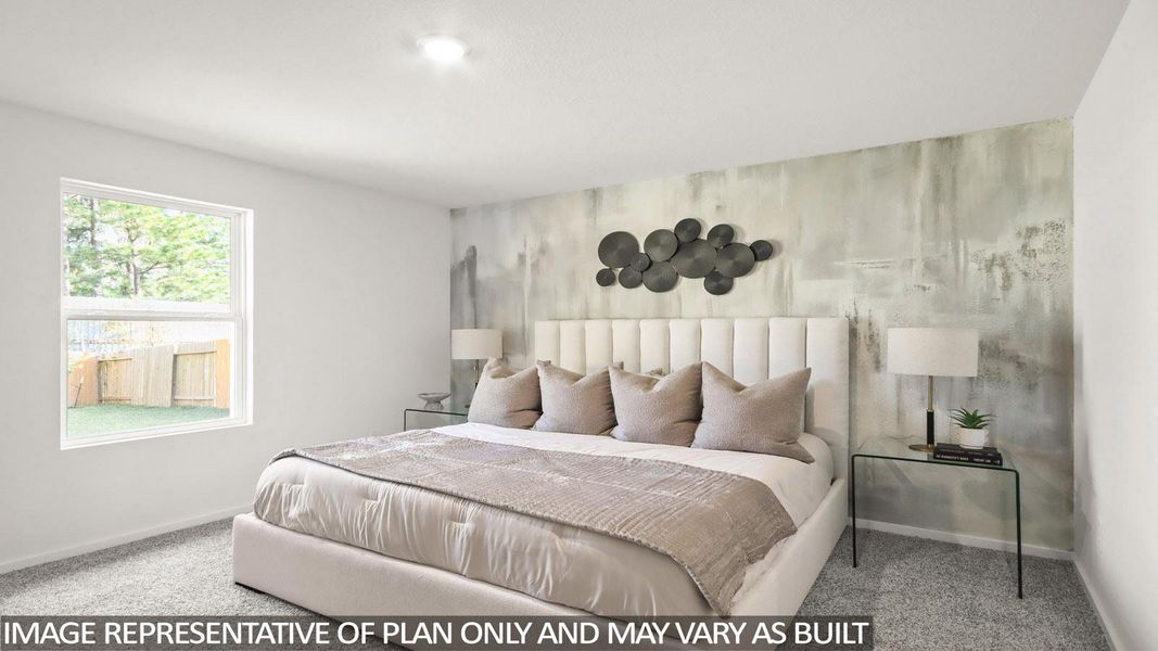 Bedroom with an accent wall and light colored carpet