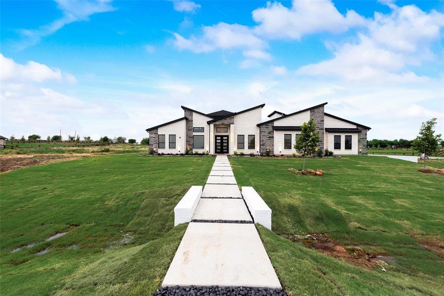 Contemporary house with a front yard, stone siding, and french doors Contemporary house with a front yard, stone siding, and french doors