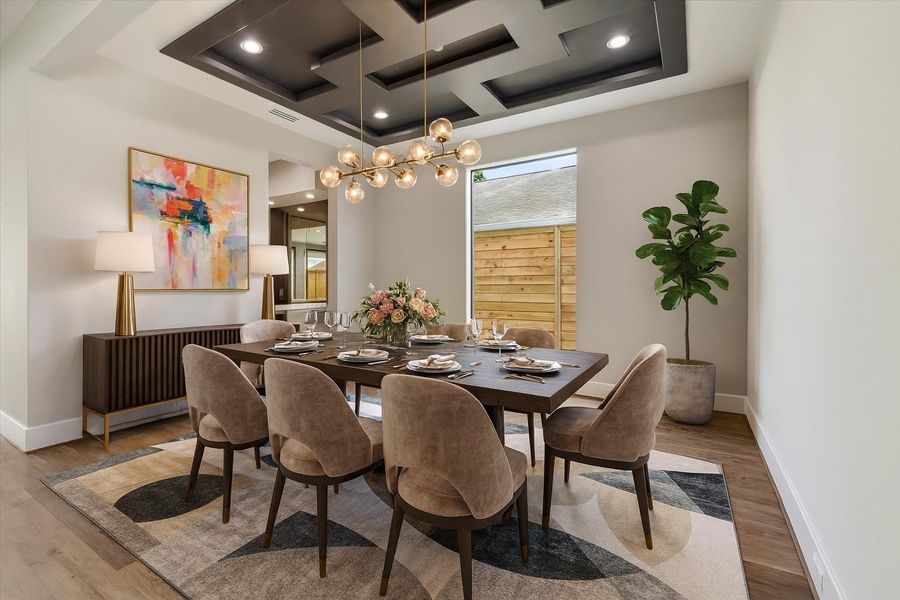 Virtually Staged. The large dining room is filled with natural light and showcases contemporary ceiling details that add style and sophistication. It offers access to the butler’s pantry/bar area and the kitchen, making it ideal for both entertaining and everyday living.