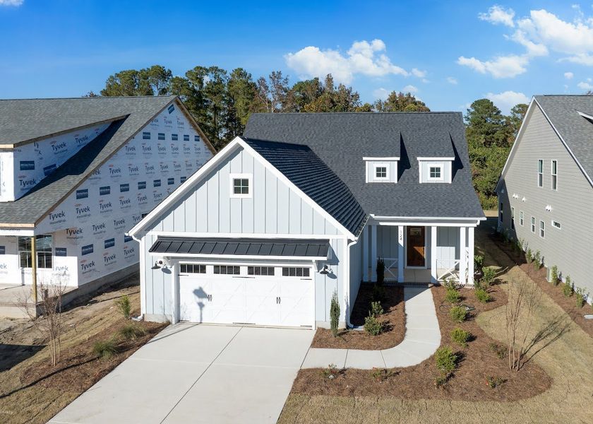 Front exterior of a new home in Riverside Cove, Wilmington, NC, highlighting curb appeal (Image 1).