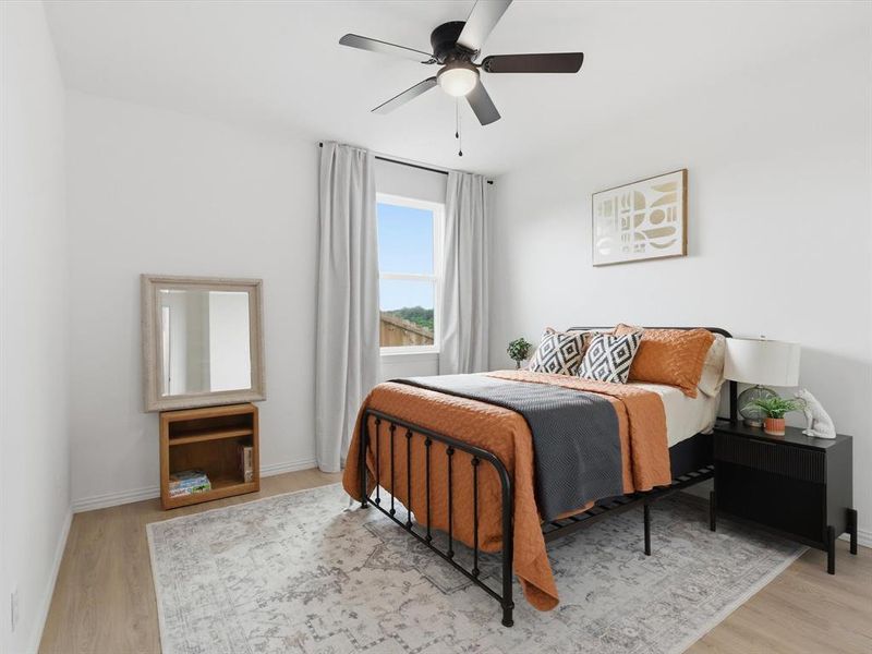 Bedroom with a ceiling fan and walk in closet.