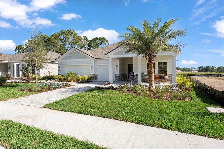 Front exterior of a new home in The Cypress Series at Reserve East, Flagler Beach, FL, highlighting curb appeal (Image 20).