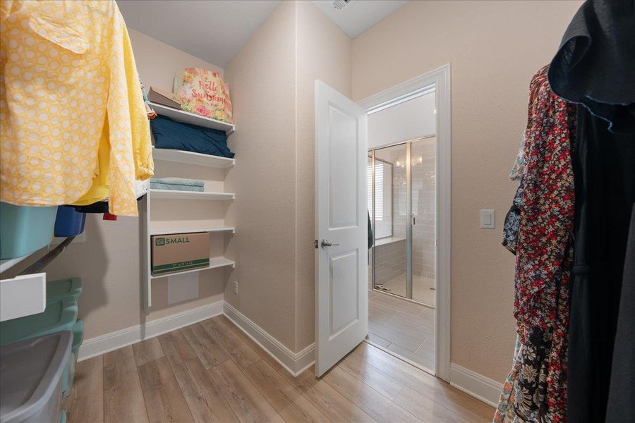 Primary closet has built in storage.