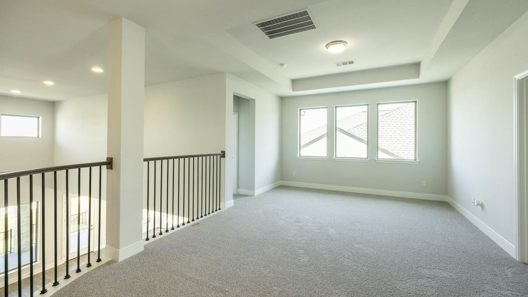 Carpeted empty room featuring recessed lighting, baseboards, and a tray ceiling Carpeted empty room featuring recessed lighting, baseboards, and a tray ceiling